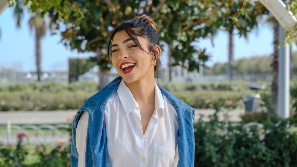 Woman smiling outdoors in natural light